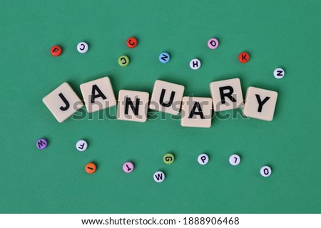 Top view of colorful alphabet beads and alphabet letters with text JANUARY.