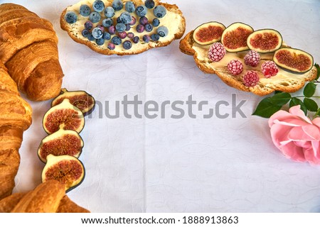 Croissant toast with butter and figs. French dip sandwich with berries raspberries for Breakfast. High quality photo