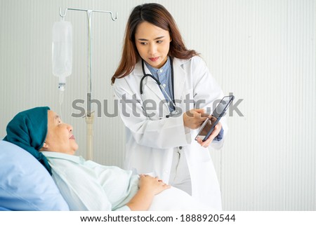 Asian attractive medical doctor standing with stethoscope white background