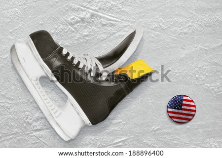Hockey skates and the puck with the image of the American flag