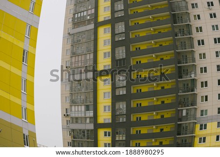 Color 2021 apartment building with fisheye distortion effect in winter isolated. Colors yellow and gray. Color of the year of 2021. Illuminating , Ultimate Gray.