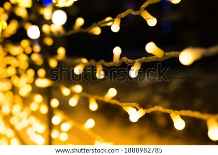 garland lights, yellow garland on black background, festive lights. christmas illumination