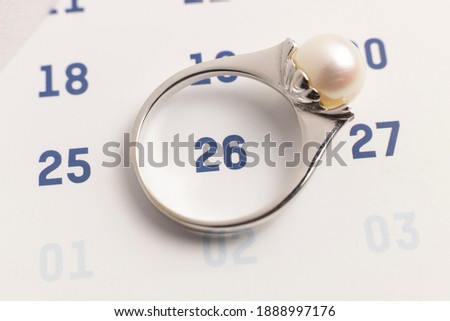 women ring on the white calendar intended as a reminder of a date