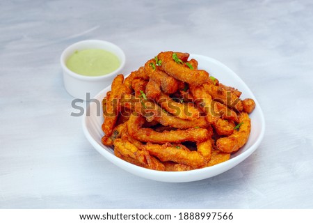 Masala fries with mint chutney. Royalty-Free Stock Photo #1888997566
