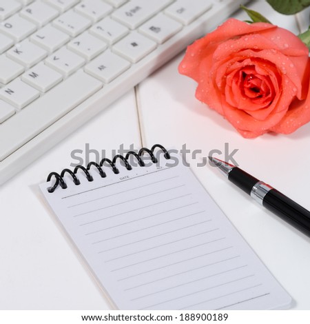 Blank notepad over laptop and coffee cup on office wooden table