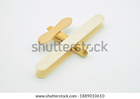 Wooden plane made with ice cream sticks and clothespins, isolated on white background