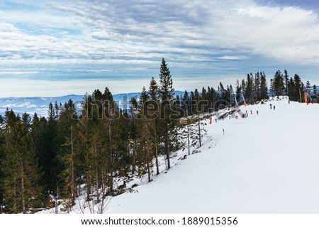 Ski resort in High Tatry, Slovakia. Winter mountain landscape.  Beautiful cloudy sky.