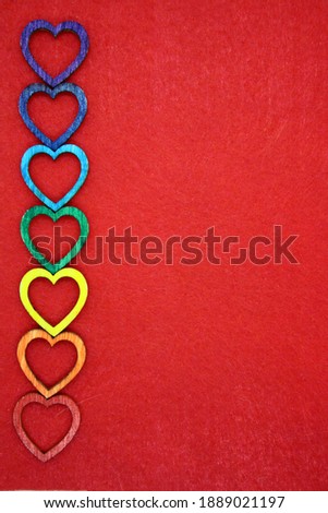 Wooden hearts on red felt. Space for text.