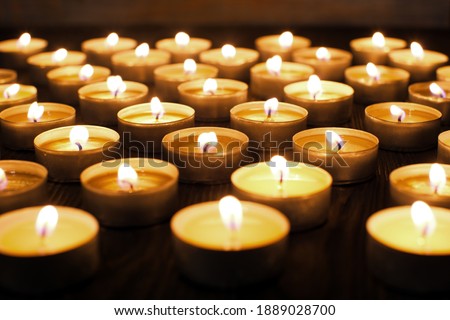 Meditation in candle light ,many candles in the dark