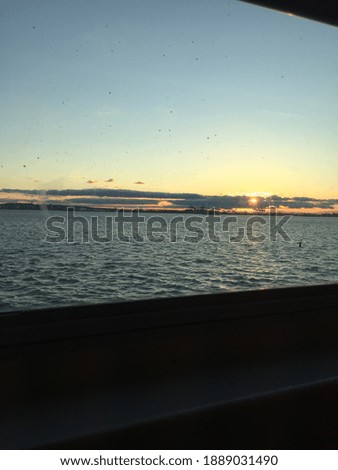 Picture of a scenic sunset overlooking the water.