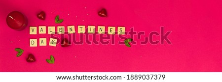 Valentine's day banner on pink background with copy space, letters and words on cubes, decoration, concept of holiday, photo