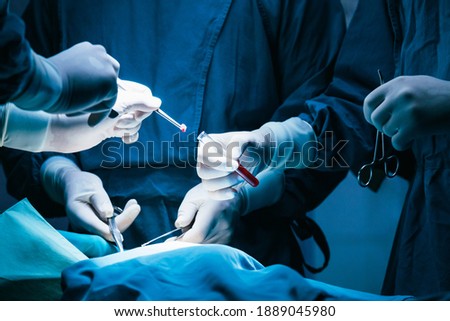 concentrated professional surgical doctor team operating surgery a patient in the operating room at hospital. tumor cancer. surgical biopsy specimens. healthcare and medical concept. Royalty-Free Stock Photo #1889045980
