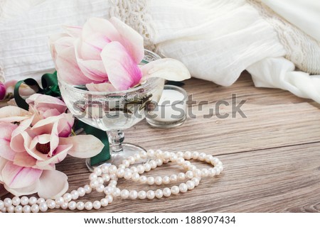 magnolia flowers with pearls and wedding dress, copy space on wooden table