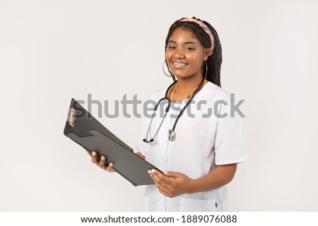 beautiful young african female on a white background in a medical gown with a folder