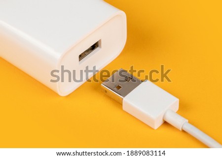 Usb cable with usb connector on yellow background.