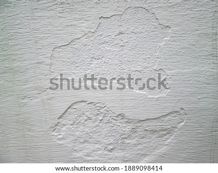 Texture of scuffs and cracks on a white wall. Stock photo to create a retro effect.