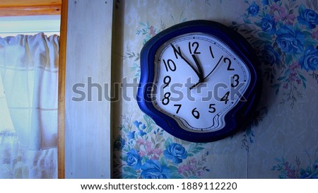 Melting clock on bathroom wall  Royalty-Free Stock Photo #1889112220