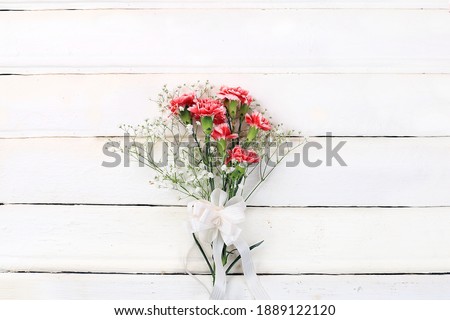 Abstract floral composition, spring background. Carnations on a wooden background, minimal holiday concept. Postcard for womens day or mothers day, happy birthday, wedding, banner for the screen,