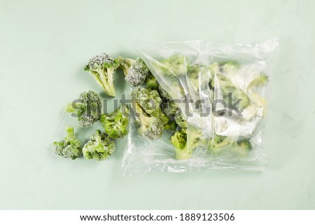 Frozen vegetables on light background with copy space. Broccoli in transparent bag. Proper defrosting of vegetables. Stock up on vitamins for winter.