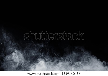 Abstract white smoke moves on black background. Swirling smoke.