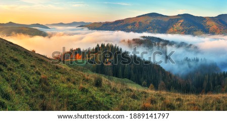 Majestic autumn rural scenery. Landscape with mountains  with morning fog