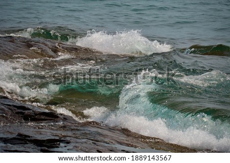 lake superior blue waves crashing into shore