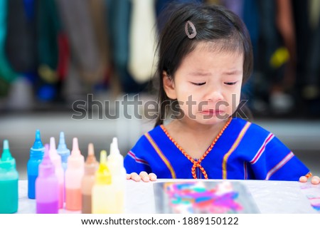 Sad child girl crying when there is a mistake in art work. Learning from mistakes. Accepting and correcting mistakes that have already occurred. Cute children 3-4 years old.