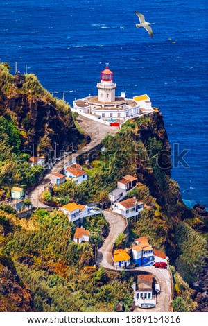 Dramatic view down to lighthouse on Ponta do Arnel, Nordeste, Sao Miguel Island, Azores, Portugal. Lighthouse Arnel near Nordeste on Sao Miguel Island, Azores, Portugal.  Royalty-Free Stock Photo #1889154316