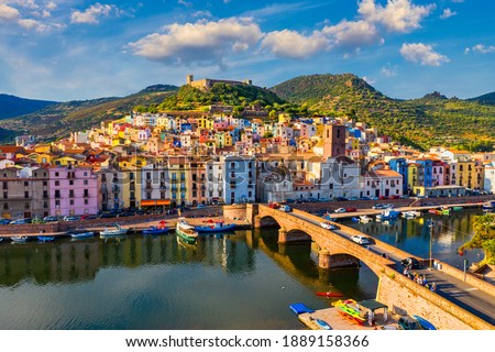 Aerial view of the beautiful village of Bosa with colored houses and a medieval castle. Bosa is located in the north-wesh of Sardinia, Italy. Aerial view of colorful houses in Bosa village, Sardegna. Royalty-Free Stock Photo #1889158366