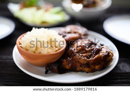 Thai food, Grilled chicken and sticky rice on wooden background, asian food