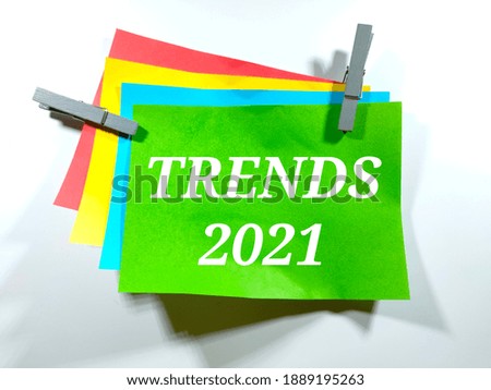 Selective focus.Text TRENDS 2021 on color paper with white background.