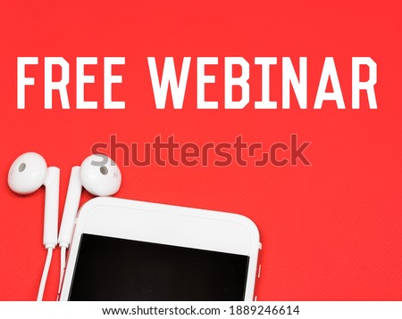 Phrase FREE WEBINAR with smartphone and earphone isolated on red background.