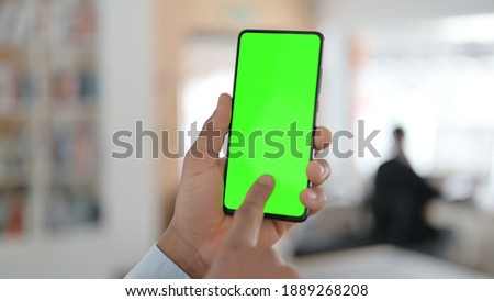 African Man using Smartphone with Green Chroma Key Screen