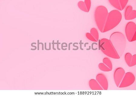 Paper elements in shape of heart on pink background. Symbols of love for Valentine's or Mother's Day, Wedding romance invitations.