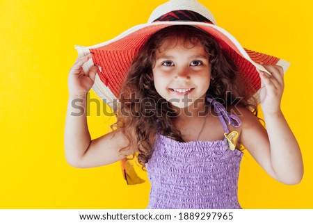 Beautiful little girl in a hat with fields