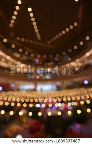 Blurry Colorful lights shining in a large room. The predominance of yellow light. Bokeh lights, defocused, great for backgrounds and wallpapers. Royalty-Free Stock Photo #1889337487