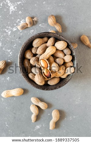 Roasted peanuts, cracked. On a grey background