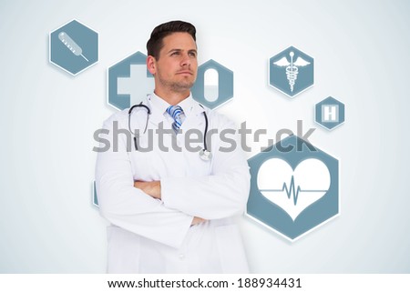 Handsome doctor with arms crossed against blue medical interface with icons
