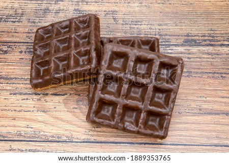 small chocolate wafer isolated on a wooden table