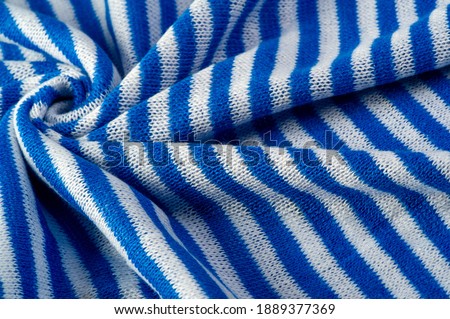 The bottom is knitted with white and blue stripes. Russian telnyashka. 