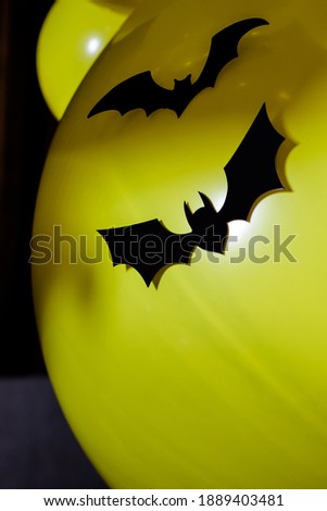 Halloween photo zone with plastic bat and yellow balloons