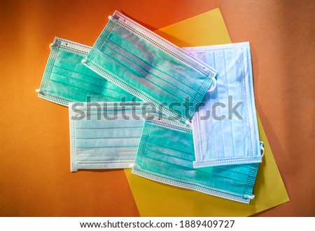 Medical mask or surgical earloop mask on Colorful paper background 