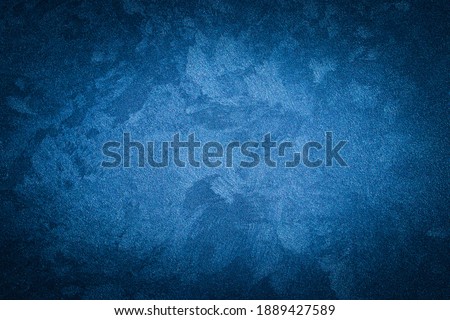 Blue decorative plaster texture with vignette. Abstract grunge background with copy space for design. Royalty-Free Stock Photo #1889427589