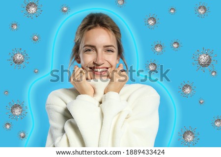 Stronger immunity - better disease resistance. Young woman wearing warm sweater surrounded by viruses on light background Royalty-Free Stock Photo #1889433424