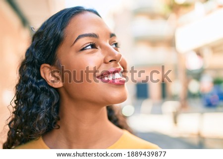 Young african american girl smiling happy walking at city.