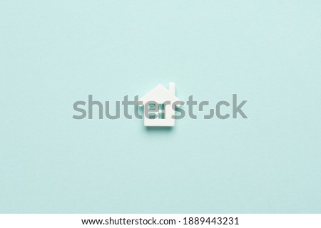 Miniature house on light blue mentol background. Top view. Buy of property, home, real estate. affordable housing. advantageous offer from the bank.