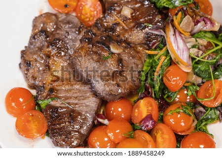 Fried meat steak. Delicious and high calorie dish. Selective focus on blurred background.