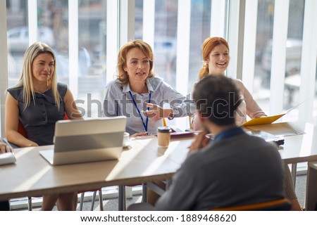 Company commission having an interview in a pleasant atmosphere with a male applicant for a job. People, job, company, business concept. Royalty-Free Stock Photo #1889468620