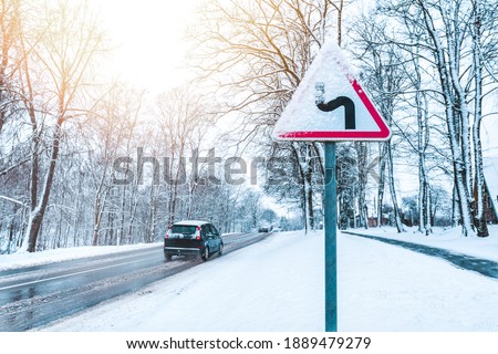 Winter Driving - Caution Snow - Curvy snowy country road