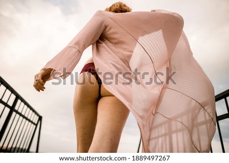a girl walking along the pier in windy weather